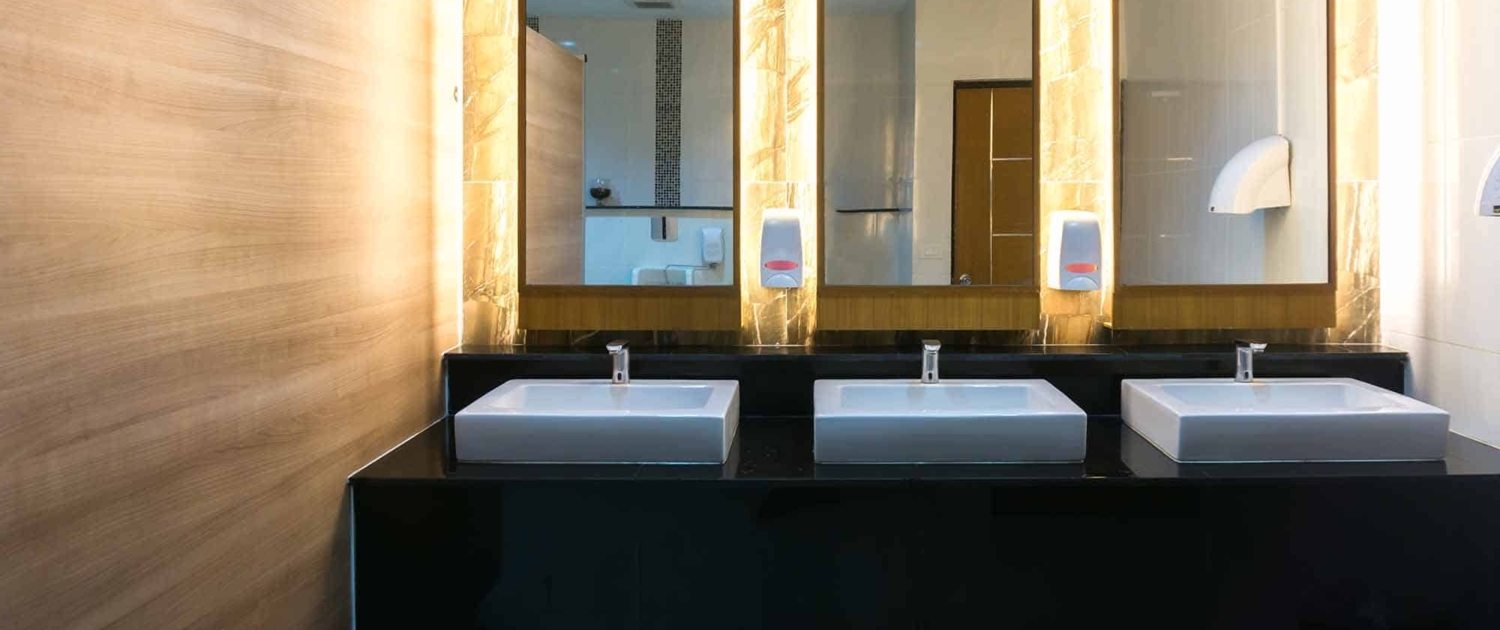 Commercial bathroom with three sinks