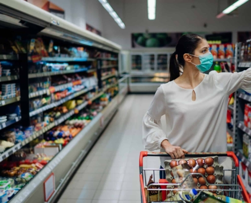 Female customer shopping in clean supermarket