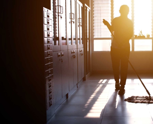 school hallway being cleaned by a worker