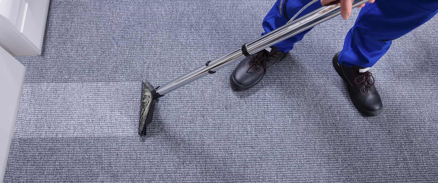 Close Up of Person Cleaning Carpet in Commercial Building