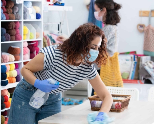 Retail workers cleaning shop