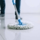 housekeeping and cleaning concept Happy young man in blue rubber gloves