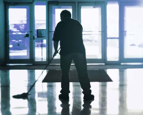 specialize services man mopping building lobby