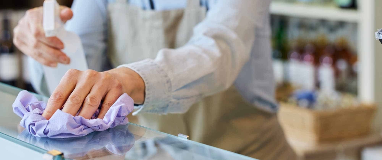 woman-wiping-a-counter-in-a-grocery-store woman wiping a counter in a grocery store