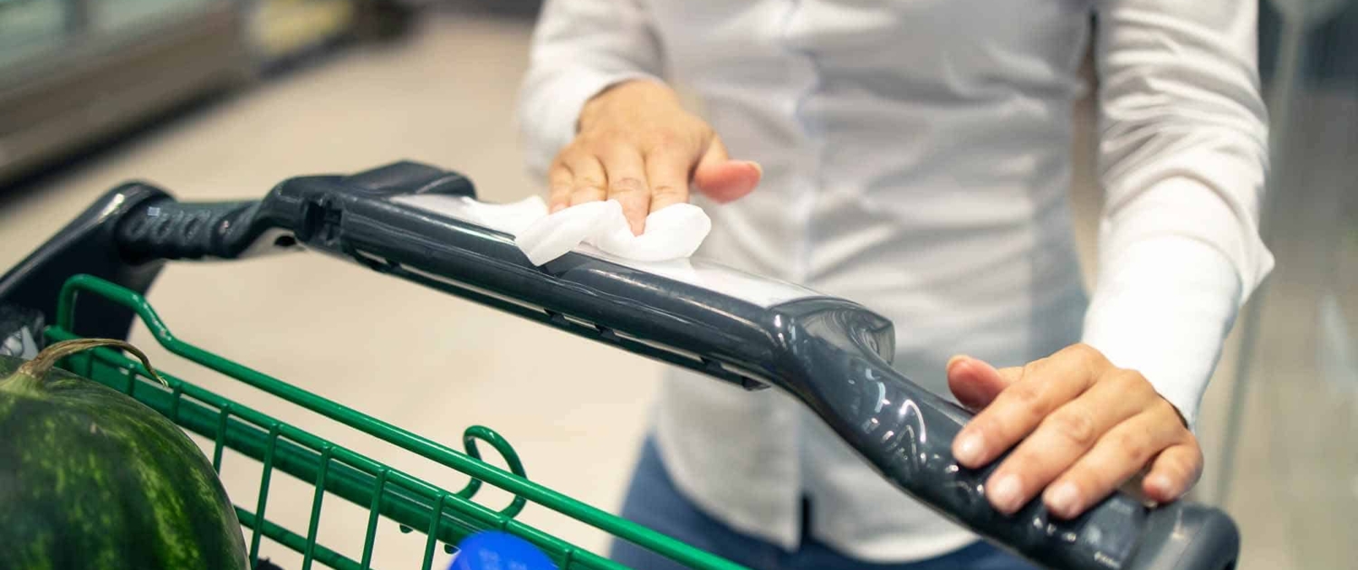 woman-wiping-a-shopping-cart woman wiping a shopping cart