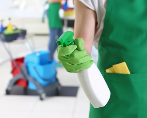 Janitor Spraying Down Surface To Clean