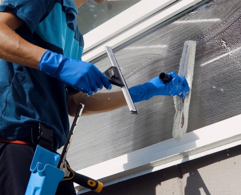 Worker Cleaning Window